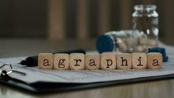palabra agrafia compuesto de de madera dados. foto