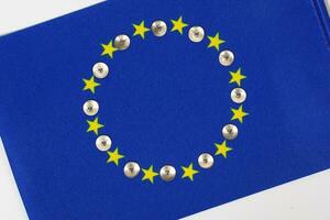 Metallic pins on an European flag.Background. Closeup photo