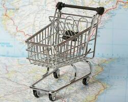 Mini shopping cart on a map. photo