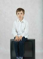 Boy and an old TV. Free space for a text. photo