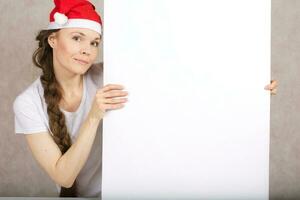 Young lady in Santa Claus hat photo