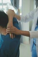 Physiotherapist working with patient in clinic, closeup photo