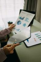 Close up of Business team analyzing income charts and graphs with modern laptop computer. Business analysis and strategy concept. photo