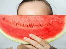 Young lady with a slice of water melon. Closeup photo