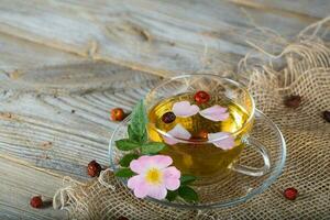 Rose hip herbal tea on a wooden surface. Free text. photo