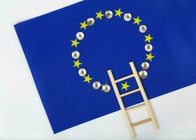 Ladder and pins on an European flag. Closeup photo