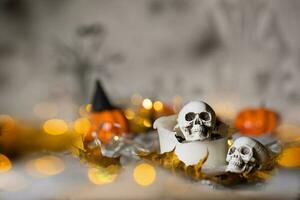 Skull on an old used thick candle. Scary Halloween background. photo