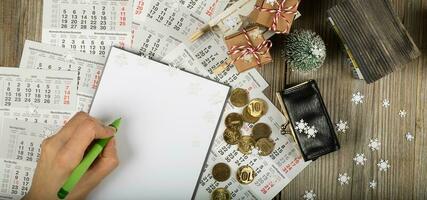 Blank sheet of paper and small purse with coins on the New Year's background. photo