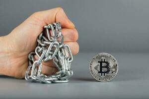 Human fist and bitcoin. photo