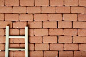 Ladder on a redbrick wall. Baackground photo