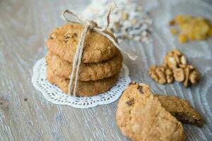 Three oat biscuits with raisins and wallnuts photo