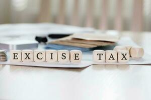 Word EXCISE TAX is composed of wooden letters. photo