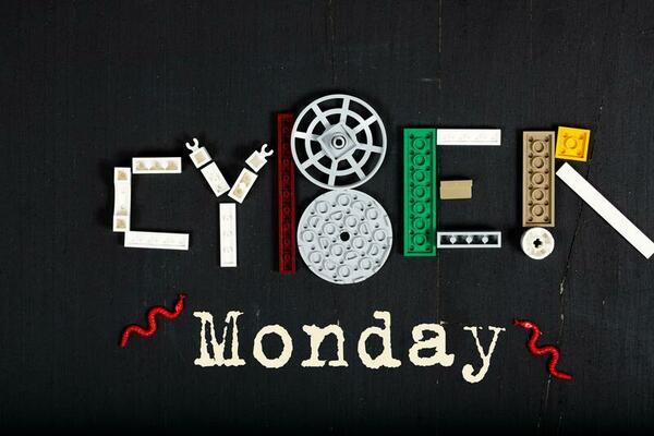 The word Cyber  is composed of plastic mini block on a black surface.Background