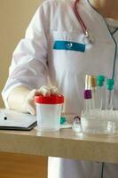 Collection cup for routine urine test. Closeup photo