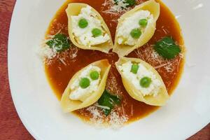 Italian pasta with ricotta cheese,green peas,and salsa photo