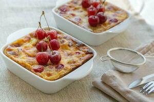 Cherry mini pies in the ceramic baking moulds photo