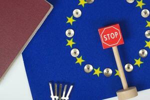 Agricultural tools,a card with access forbidden,pins,and a passport on an European flag.Closeup photo