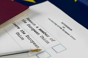 EU Referendum ballot paper, black pen, and passport on the table. photo