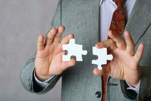 Puzzle in the hands of a man in a classical costume photo