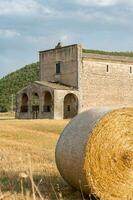 Navelli, Italy-august 9, 2021-view of the Church of the Madonna del Campo in the open countryside during a sunny day photo