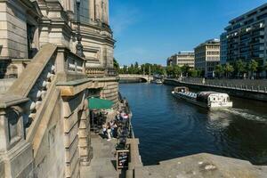 Berlin, Germany-august 9, 2022-Walking on the river sprea near the cathedral in Berlin during a sunny day photo