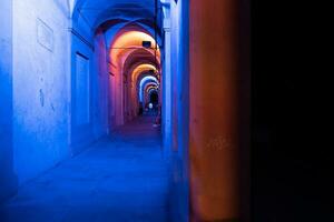 Bologna,Italy- June 23, 2023-People stroll at night under the arcades leading to the sanctuary of San Luca illuminated for the first edition of the Bologna arcades Festival. photo