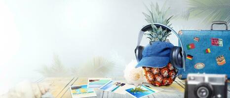Nautical concept with palm leaf, beach hat, seashells and pineapple. photo