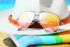 Summer tropical beach background with sunglasses and hat. photo