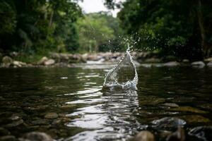 Splash made with a stone falling into the water of the waterfall in Paraty in Rio de Janeiro photo