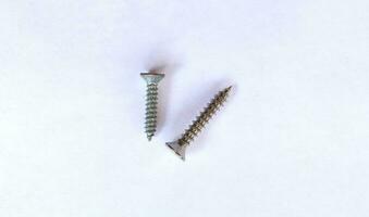 Self-tapping screw isolated on white background with clipping path. Screw bolt isolated. Nuts and bolts. Tools for work. photo