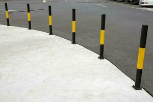Protective yellow fence for pedestrians in front of the park photo