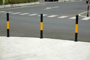 Protective yellow fence for pedestrians in front of the park photo