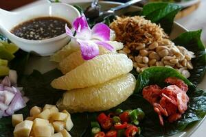 Miang kham - A royal leaf wrap appetizer. Asian snack from Thailand photo