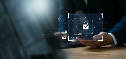 Cyber security and data protection, businessman using laptop and smartphone Internet network security system, protecting business and financial transaction data from cyber-attacks. photo