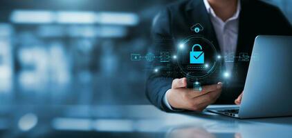 Cybersecurity data protection, businessman using laptop and smartphone internet network security, protect business financial transaction data from cyber attack, user private data security encryption. photo