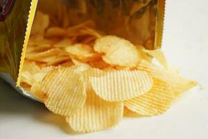 Potato chips in open bag, delicious BBQ seasoning spicy for crips, thin slice deep fried snack fast food. photo