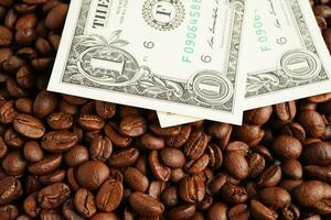 US dollar banknotes on coffee beans, shopping online for export or import. photo