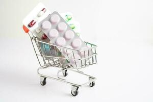 Shopping trolley with blister pill and capsule from drug prescription, pharmacy for treatment health medicine. photo