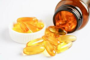 Fish oil or Cod liver oil gel in capsules with omega 3 vitamins, supplementary healthy food photo