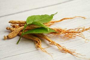 Ginseng roots and green leaf, healthy food. photo
