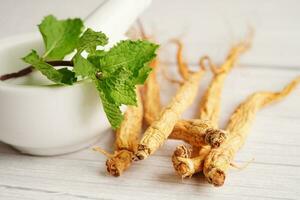 Ginseng roots and green leaf, healthy food. photo