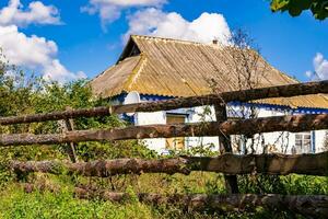 Beautiful old abandoned building farm house in countryside on natural background photo