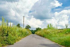 Beautiful empty asphalt road in countryside on colored background photo