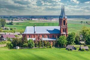 aerial view on neo gothic or baroque temple or catholic church in countryside photo