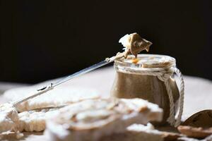 Homemade almond butter on a slice of rice crispbread. photo