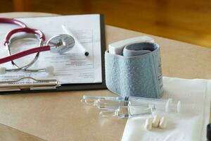 Medical tools,lab analysis,pen,blood analysis in French results,medication on a doctors table. Medication for injection on a doctors table photo