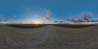 360 hdri panorama on gravel road with evening clouds on blue sky before sunset in equirectangular spherical seamless projection, use as sky replacement in drone panoramas, game development as sky dome photo