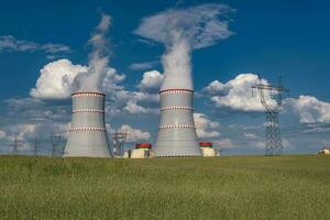 Cooling towers of nuclear power plant against the blue sky photo