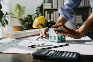 architect man working with laptop and blueprints,engineer inspection in workplace for architectural plan,sketching a construction project ,selective focus,Business concept vintage color photo