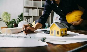 architect man working with laptop and blueprints,engineer inspection in workplace for architectural plan,sketching a construction project ,selective focus,Business concept vintage color photo